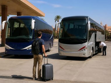 Two modern intercity coaches at a Moroccan bus terminal