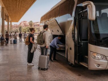 Modern intercity coach at a Moroccan bus station with travelers preparing to board