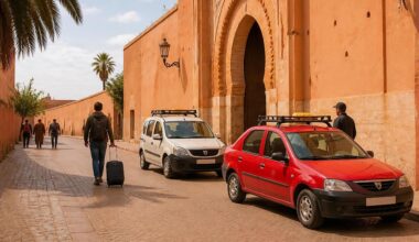 Petit taxi and grand taxi waiting near a Moroccan medina
